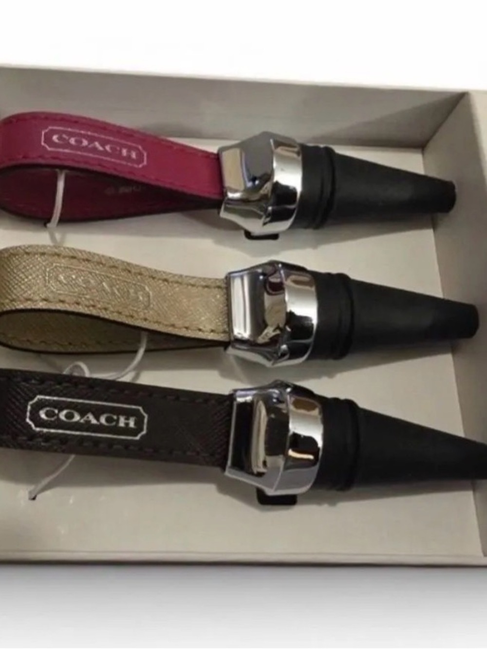 Coach Leather Loop Wine Stoppers in Pink, Gold, and Brown
